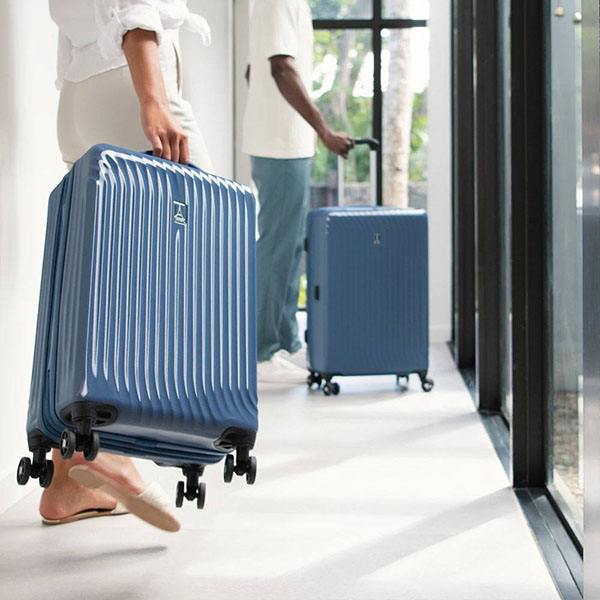 two travelpro suitcases standing next to each other in a hallway